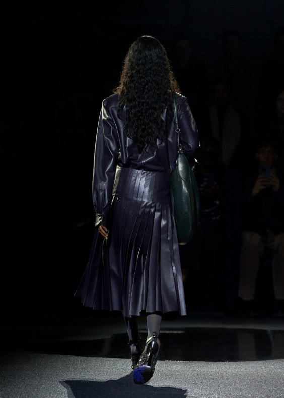 Pleated leather and a slouched green bag
