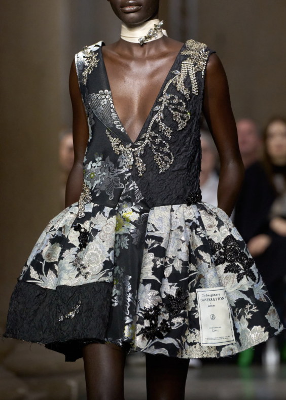 Beading, lace and an invitation pinned at the hip