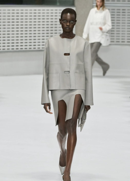 Flap-edged tailoring over a sheer skirt