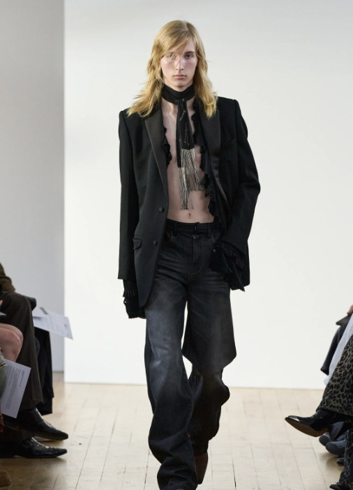 A long black blazer over low-slung denim