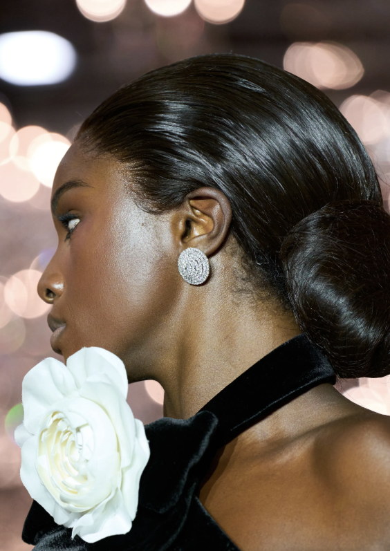 Lacquered hair and a single white bloom