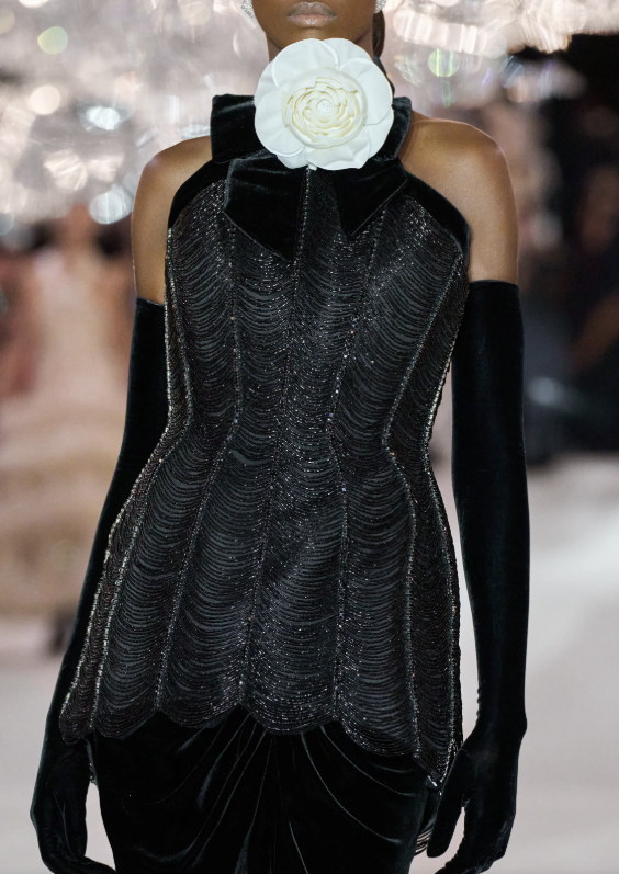 A corseted black gown with opera gloves